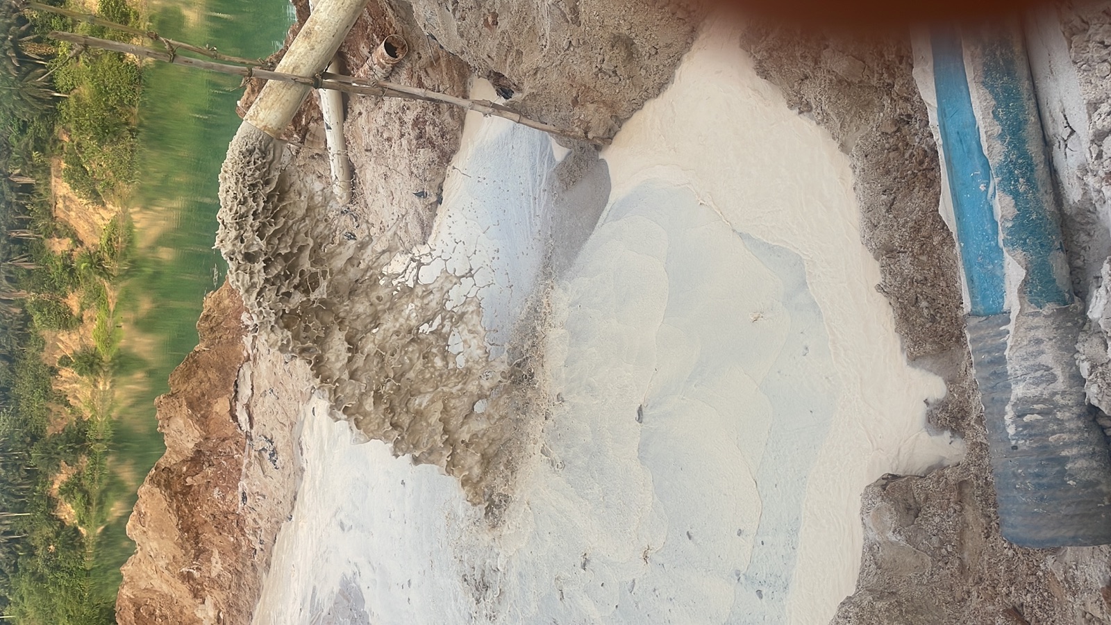 Discharge pipeline depositing white sand slurry
