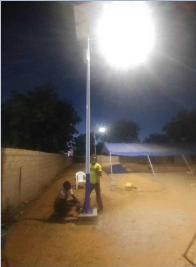 Crew installing a solar street light at an energy worksite
